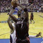 Miami Heat center Jermaine O'Neal (7) goes up for a basket in front of Orlando Magic guard Vince Carter during an NBA basketball game in Orlando, Fla., Wednesday, Nov. 25, 2009. Miami won 99-98. (AP Photo/John Raoux)