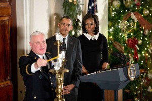 President Barack Obama, First Lday Michelle Obama and Rabbi Larry Bazer participate in the Menorah lighting during the Hanukkah reception in the Grand Foyer of the White House, December 13, 2012 (Photo: White House/Pete Souza)