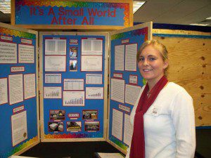 A student stands beside her display at a previous Science Challenge (Photo: OSC)