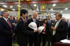 Florida Governor Rick Scott (center) is presented with ceremonial hard hats by Mitsubishi Power Systems Americas, Inc. executives following his tour of the company's Orlando manufacturing center. Joining him on the plant tour are (left-to-right) Bob Provitola, MPSA's Orlando facility's General Manager, Koji Hasegawa, Mitsubishi Power Systems Americas president and CEO, (Governor Scott) and Dave Walsh MPSA's senior vice president.  (PRNewsFoto/Mitsubishi Power Systems Americas, Inc.)