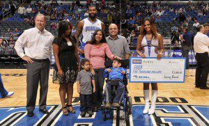 Kyle O’Quinn was named the Aleve-Publix ‘Hustle Player of the Year’ at halftime of the Orlando Magic’s regular season home finale Monday evening against the Chicago Bulls. O’Quinn accepted the award from Larry Bond with Bayer Healthcare, who represented Aleve, and Maria Brous with Publix Super Markets. (Photo: Gary Bassing)