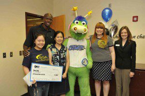 Left to right: Seminole High School student Dana Liang, Magic Community Ambassador Bo Outlaw, Meizhen Mai (Liang’s mother), STUFF the Magic Mascot, Orlando Magic Youth Foundation Administrator Stephanie Allen, Seminole State College Foundation Scholars Program Success Coach Tanya Fritz.  Liang was surprised in her school by Magic representatives with news of her $6,000 Seminole State OMYF Scholarship on May 1.  Photo taken by Gary Bassing.    
