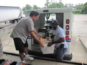 Orlando Letter Carrier unloading a mail truck full of food to feed needy, May 11, 2013 