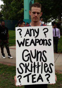 Steven Mikan holds a sign at the "March Against Gun Violence" at Lake Eola, Orlando, July 17, 2013 (Photo: WONO)