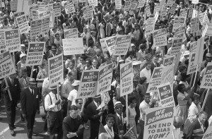 Demonstrators marching in the street holding signs during the March on Washington, 1963. Photo by: Marion S. Trikosko.