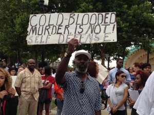 A protester holds up a placard at a rally calling for equal justice, Lake Eola, Orlando, July 17, 2013 (Photo: WONO)