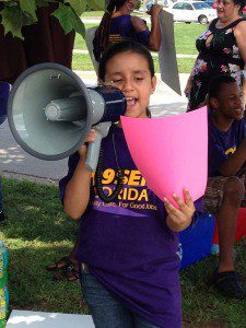 8-year-old Emilia takes the megaphone to rally workers at 