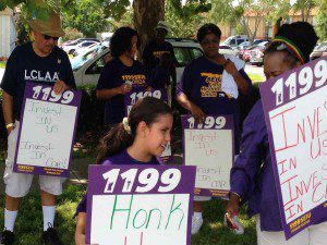 State Rep. Victor Torres (l) joined health care workers and members of 1199SEIU to protest against low wages and work conditions of employer Consulate Health Care, 