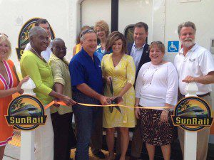 lState and local elected officials cut the ribbon in front of a SunRail vehicle. Left to right: Orlando City Commissioner Daisy Lynum, Central Florida Commuter Rail Commission Chairman Frank Attkisson and FDOT Secretary Norranne Downs, Central Park, Winter Park, September 21, 2013. (Photo: WONO)