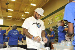 Orlando Magic guard Jameer Nelson and volunteers from Chase and Evans Community School in Pine Hills package food boxes (Photo credit: Gary Bassing/Orlando Magic)