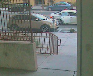 Photo of the suspect in the suspect vehicle, as he opens the rear door. (OPD)