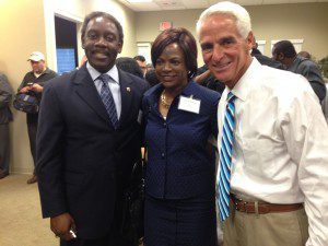 Orange County Sheriff Jerry Demings and wife Val Demings, pose with former Gov. Charlie Crist at open house reception, Synergy Settlement Services, 911 Outer Road, Orlando. June 26, 2014. (Photo: WONO)