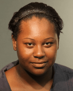 Latoya Rolle, who smiles for her booking photo, faces child neglect charges.  
