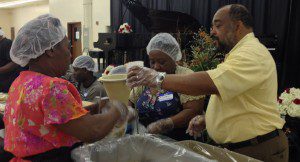 File photo: Derrick Wallace, candidate for District 6 Orange County Commission, helps package 50,000 meals at the End Time Sabbath Worship Center on Orlando's west side, March 23, 2013. (Photo: WONO)