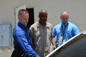 Richard McKinney (c) - suspect - being escorted into a vehicle by two Orange County Sheriff's detectives, June 20, 2014. (Photo: OCSO).