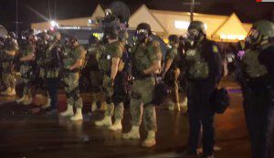 Police fire tear gas at Ferguson Protestors, August 15, 2014. (Elite Daily - Youtube still)