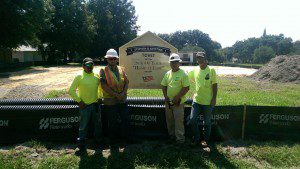 Four Tucker Paving workers stand in front of the job site
